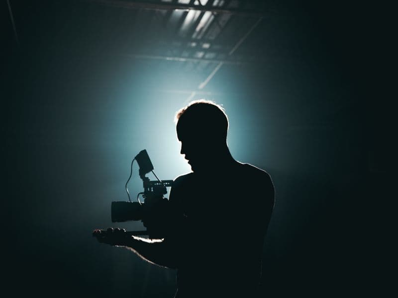 Content creator holding a smartphone to record vertical social media content